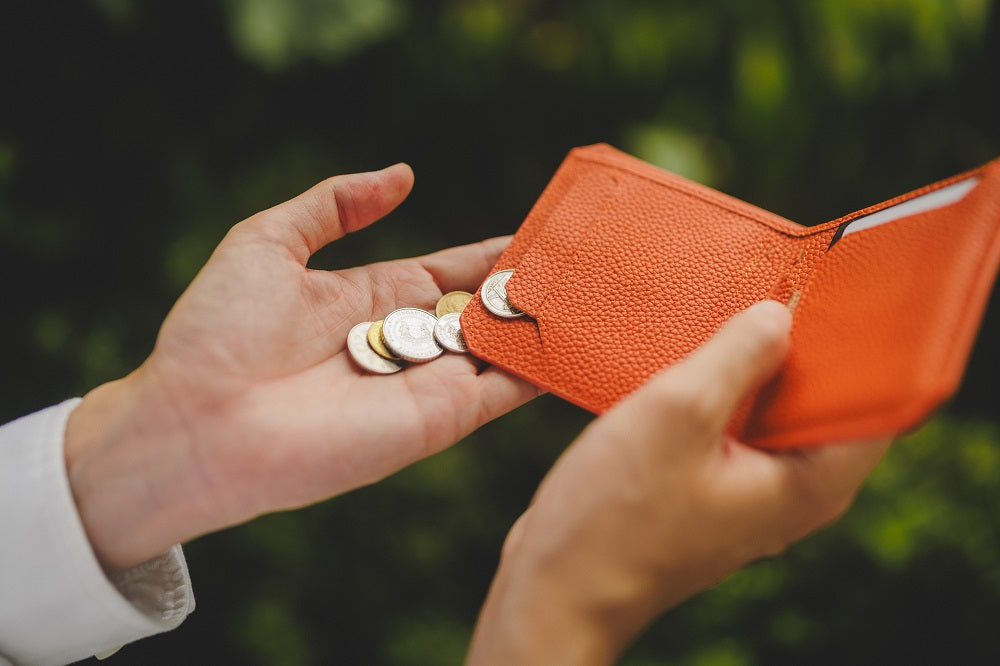 Using the coin flap for coins in Kaizen orange wallet